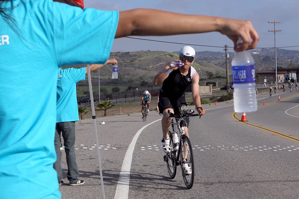 1024px-ryan_jackson_drinks_cold_water_handed_out_by_volunteers_during_the_bike_portion_of_the_ironman_70-3_at_oceanside_calif-_march_30_2013_130330-m-ld192-933